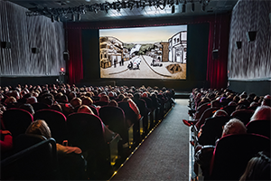 Photo: People watching the movie in a theatre.